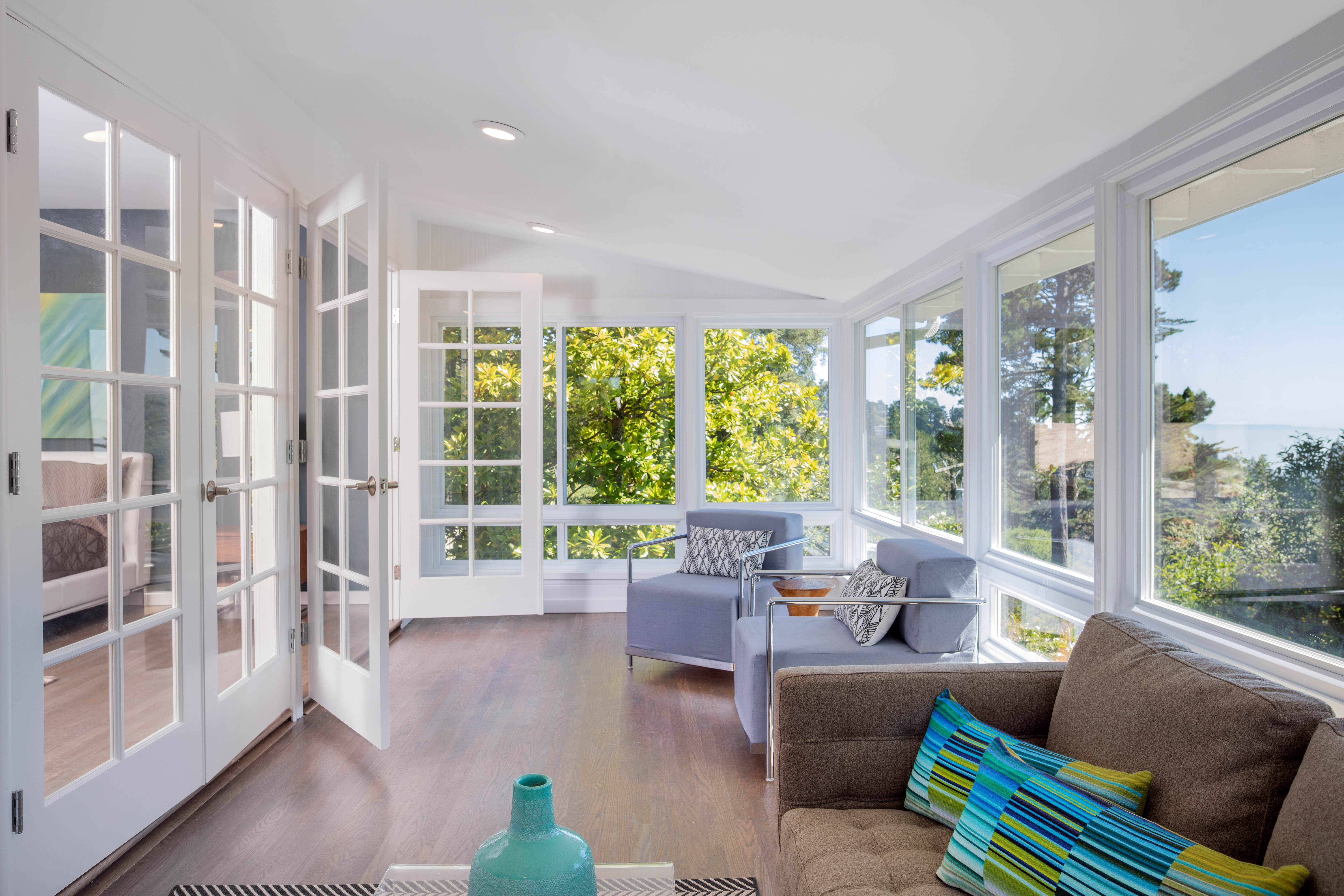 beautiful, white sunroom with lots of windows and natural light