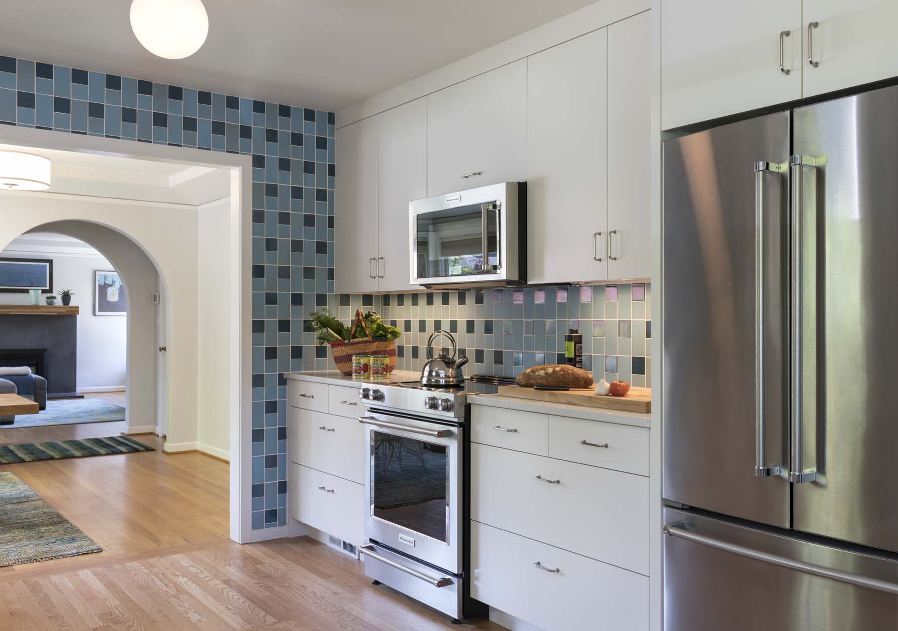 beautiful modern kitchen with blue tiles and white cabinets